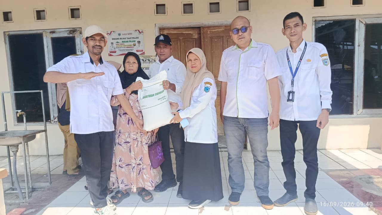 Caption : Warga Desa Purwaraja, Kecamatan Menes, menerima bantuan beras dari Pemerintah di kantor desa setempat.